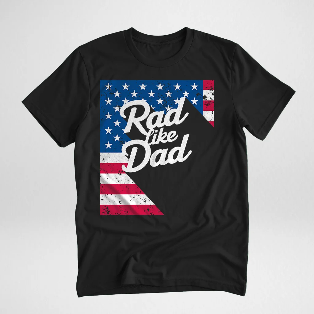 Black t-shirt with the text 'Rad Like Dad' in a bold, cursive font, featuring a distressed American flag pattern, displayed flat on a light background.